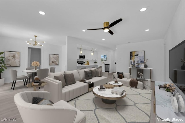 1317 Pyramid Dr, Las Vegas, NV 89108 - living area featuring light wood-type flooring, recessed lighting, a chandelier, and a ceiling fan