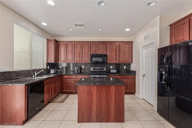 9221 Thunder Falls Ct, Las Vegas, NV 89149 - kitchen with black appliances, a center island, backsplash, dark stone counters, and light tile patterned floors