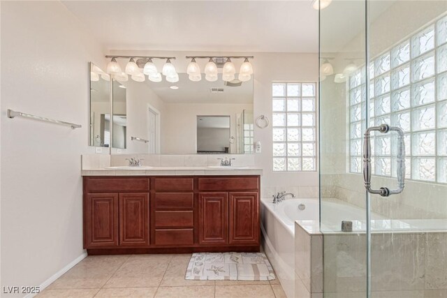 9221 Thunder Falls Ct, Las Vegas, NV 89149 - bathroom featuring a bath, healthy amount of natural light, double vanity, and tile patterned floors