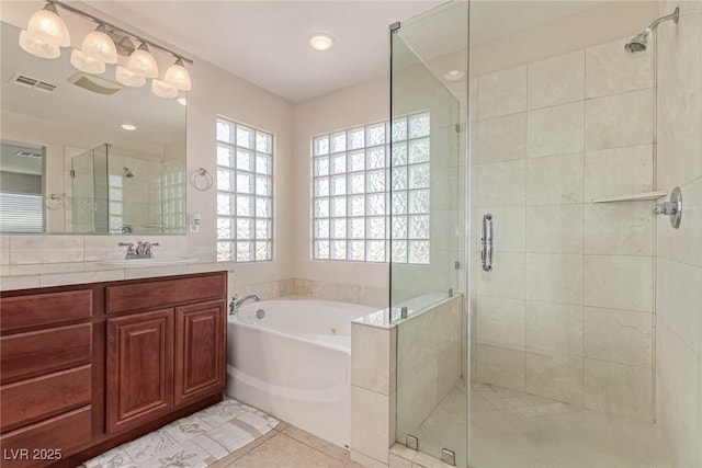 9221 Thunder Falls Ct, Las Vegas, NV 89149 - bathroom with a garden tub, a stall shower, vanity, tile patterned floors, and recessed lighting