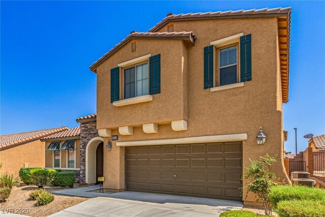 9221 Thunder Falls Ct, Las Vegas, NV 89149 - mediterranean / spanish home with stucco siding, concrete driveway, a tiled roof, and an attached garage