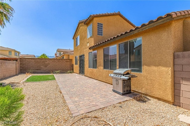 9221 Thunder Falls Ct, Las Vegas, NV 89149 - fenced backyard with grilling area and a patio