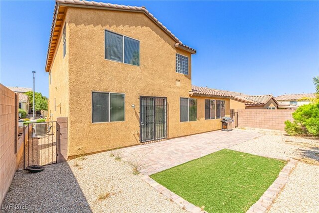 9221 Thunder Falls Ct, Las Vegas, NV 89149 - back of property with stucco siding, a fenced backyard, a patio, and a tiled roof