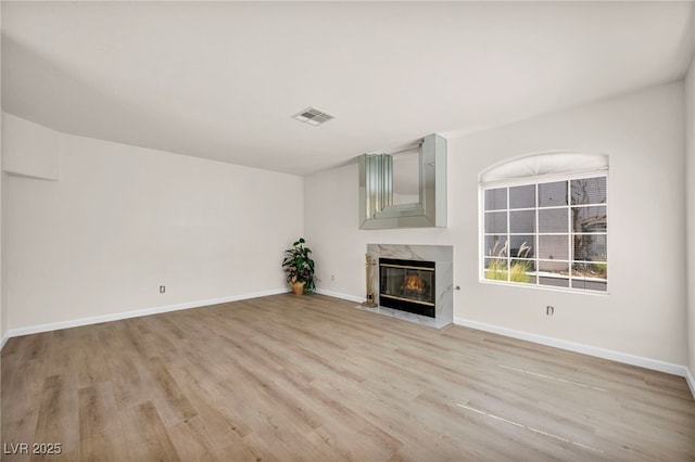 3448 Twilight Star Dr, Las Vegas, NV 89117 - unfurnished living room featuring a premium fireplace and light wood-style floors