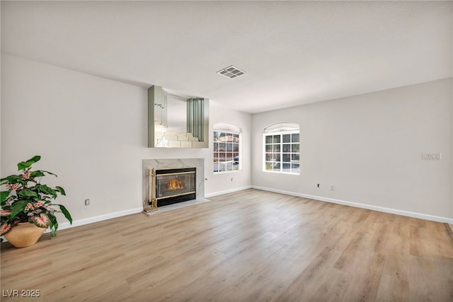 3448 Twilight Star Dr, Las Vegas, NV 89117 - unfurnished living room with light wood-type flooring and a premium fireplace