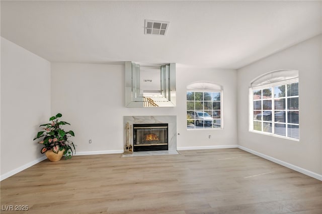 3448 Twilight Star Dr, Las Vegas, NV 89117 - unfurnished living room featuring light wood-style flooring and a premium fireplace