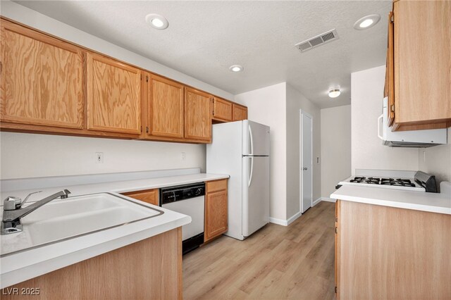 3448 Twilight Star Dr, Las Vegas, NV 89117 - kitchen with white appliances, light wood-type flooring, light countertops, and recessed lighting