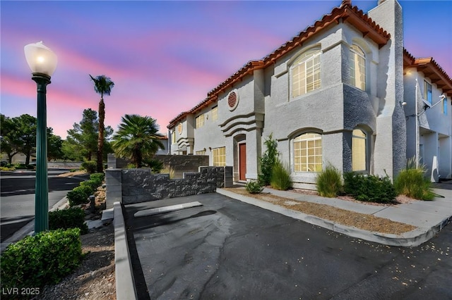 3448 Twilight Star Dr, Las Vegas, NV 89117 - mediterranean / spanish-style house with a tile roof, uncovered parking, a chimney, and stucco siding