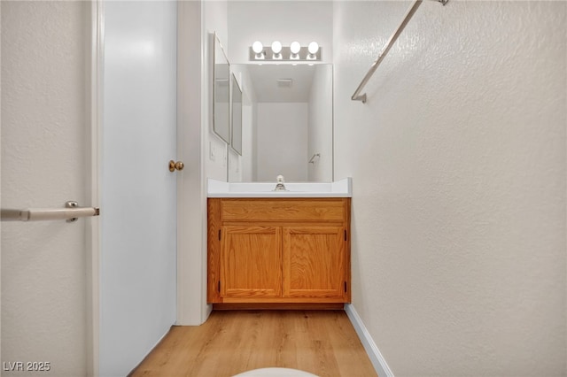 3448 Twilight Star Dr, Las Vegas, NV 89117 - bathroom featuring wood finished floors, vanity, and a textured wall