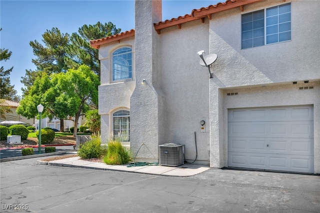 3448 Twilight Star Dr, Las Vegas, NV 89117 - view of front of home featuring stucco siding, a tiled roof, and an attached garage