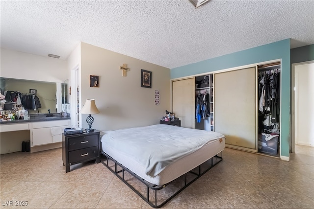 2297 Casey Dr, Las Vegas, NV 89119 - bedroom with a closet and a textured ceiling