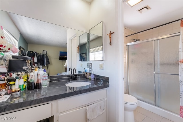2297 Casey Dr, Las Vegas, NV 89119 - bathroom featuring a stall shower, vanity, tile patterned floors, and a textured ceiling