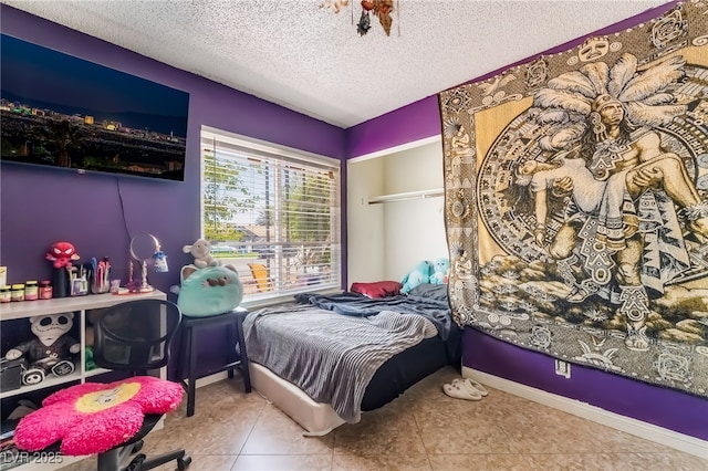 2297 Casey Dr, Las Vegas, NV 89119 - bedroom featuring a textured ceiling and tile patterned flooring