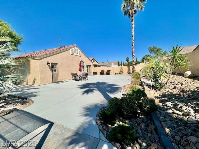 3197 Dusty Moon Ave, Henderson, NV 89052 - fenced backyard with a patio area