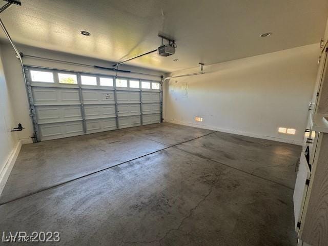 3197 Dusty Moon Ave, Henderson, NV 89052 - garage with a garage door opener and baseboards