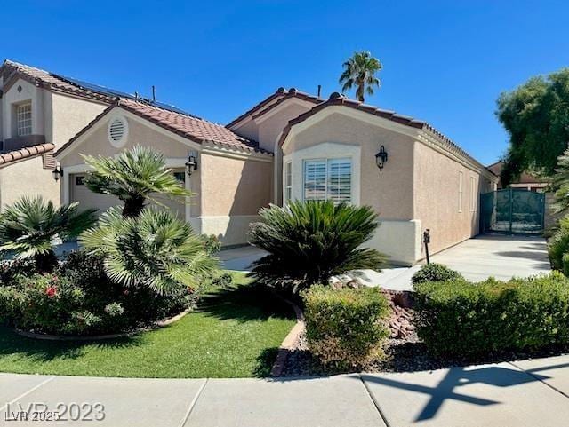 3197 Dusty Moon Ave, Henderson, NV 89052 - view of front of house featuring a garage, stucco siding, and a tiled roof
