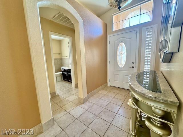 3197 Dusty Moon Ave, Henderson, NV 89052 - foyer entrance featuring arched walkways, light tile patterned floors, and plenty of natural light
