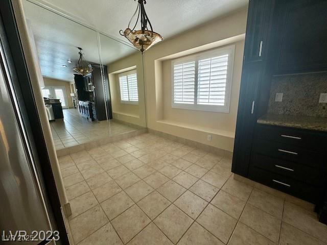 3197 Dusty Moon Ave, Henderson, NV 89052 - unfurnished dining area featuring light tile patterned floors and baseboards
