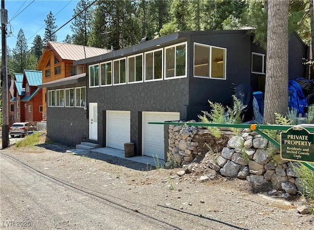 4651 Aspen Ave, Mount Charleston, NV 89124 - view of front of property with a garage, driveway, and stucco siding