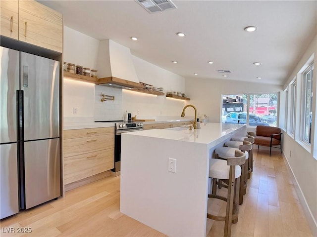4651 Aspen Ave, Mount Charleston, NV 89124 - kitchen with stainless steel appliances, modern cabinets, custom exhaust hood, light wood-style floors, and recessed lighting