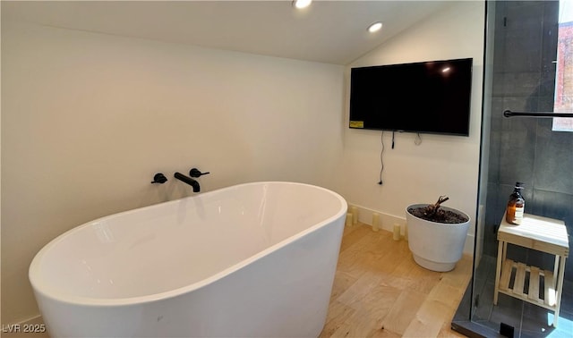 4651 Aspen Ave, Mount Charleston, NV 89124 - bathroom with wood finished floors, a freestanding bath, vaulted ceiling, and recessed lighting
