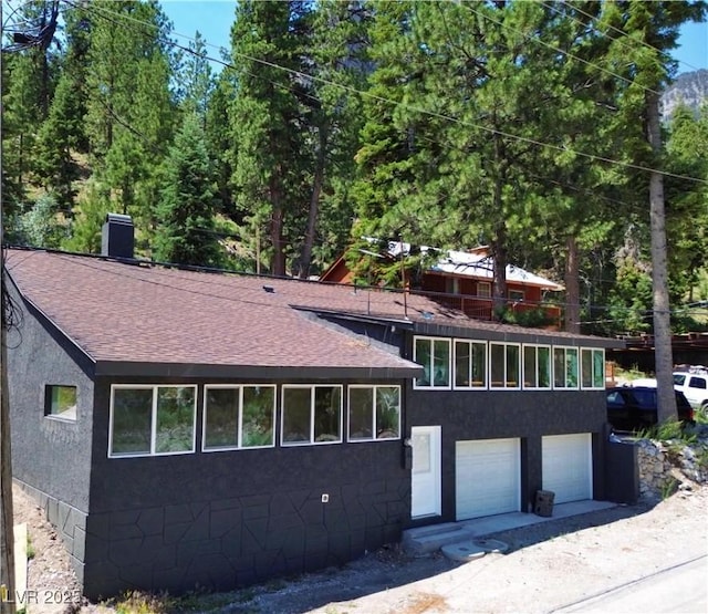 4651 Aspen Ave, Mount Charleston, NV 89124 - view of front of home featuring roof with shingles and an attached garage