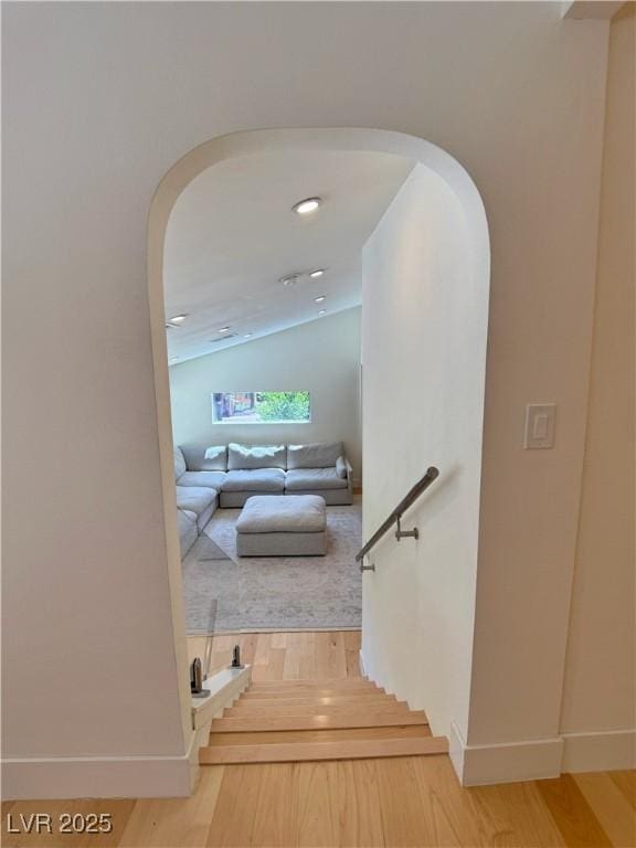 4651 Aspen Ave, Mount Charleston, NV 89124 - staircase featuring arched walkways, wood finished floors, and vaulted ceiling