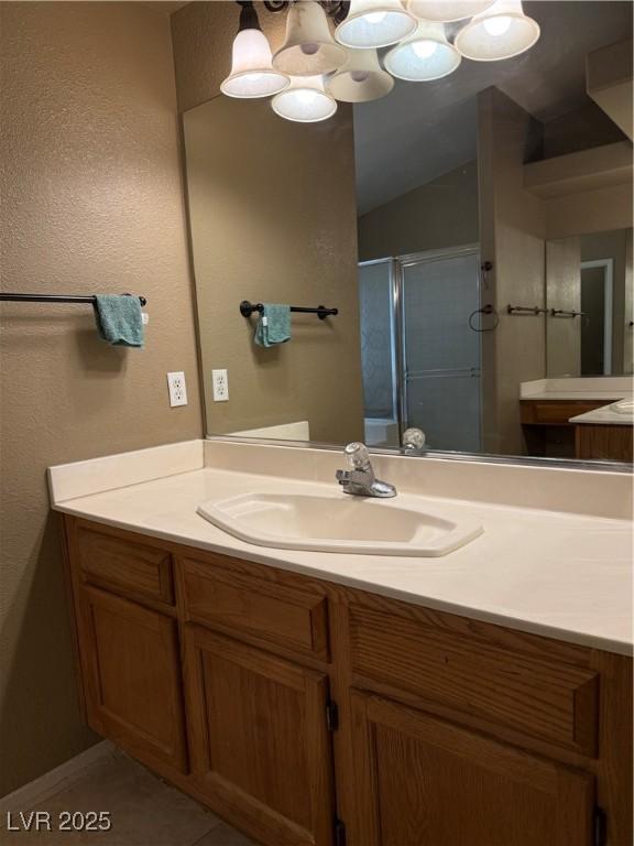 5315 Debut Ct, North Las Vegas, NV 89031 - bathroom featuring vanity, a stall shower, and a textured wall