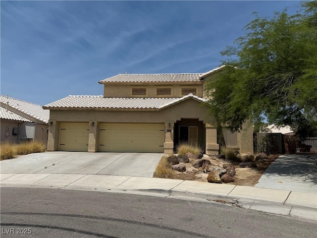 5315 Debut Ct, North Las Vegas, NV 89031 - mediterranean / spanish house with stucco siding, a tile roof, concrete driveway, and a garage