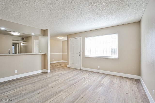 4348 Tara Ave Unit 2, Las Vegas, NV 89102 - unfurnished room featuring wood finished floors and a textured ceiling