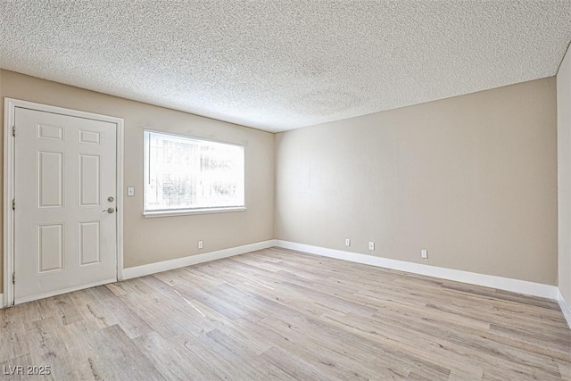 4348 Tara Ave Unit 2, Las Vegas, NV 89102 - unfurnished room featuring light wood finished floors and a textured ceiling