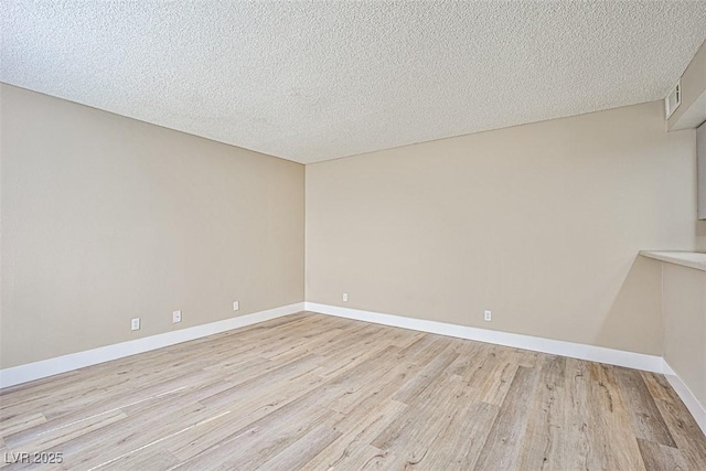 4348 Tara Ave Unit 2, Las Vegas, NV 89102 - empty room featuring light wood-style flooring and a textured ceiling