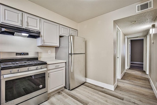 4348 Tara Ave Unit 2, Las Vegas, NV 89102 - kitchen with under cabinet range hood, appliances with stainless steel finishes, light wood-style floors, and light countertops