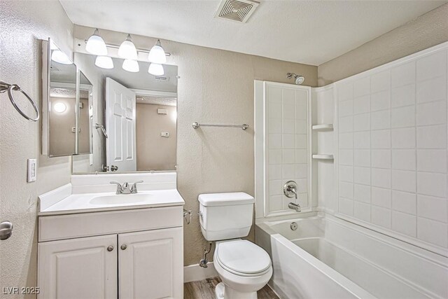 4348 Tara Ave Unit 2, Las Vegas, NV 89102 - full bathroom featuring a textured wall, vanity,  shower combination, and wood finished floors