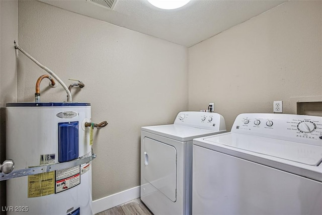 4348 Tara Ave Unit 2, Las Vegas, NV 89102 - laundry area with electric water heater, washer and clothes dryer, and light wood-style flooring