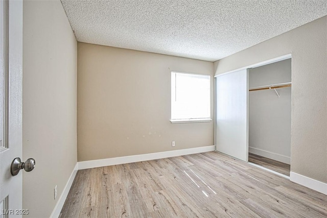 4348 Tara Ave Unit 2, Las Vegas, NV 89102 - unfurnished bedroom featuring wood finished floors, a textured ceiling, and a closet
