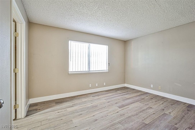4348 Tara Ave Unit 2, Las Vegas, NV 89102 - spare room featuring wood finished floors and a textured ceiling