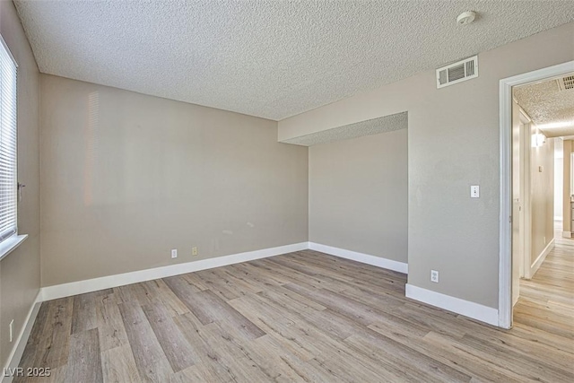 4348 Tara Ave Unit 2, Las Vegas, NV 89102 - empty room with a textured ceiling, wood finished floors, and a smoke detector