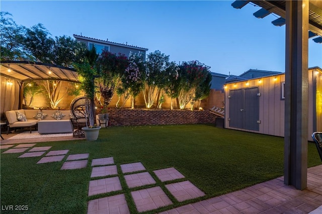 10183 Cascadia Creek St, Las Vegas, NV 89141 - fenced backyard featuring a patio, an outdoor living space, and a storage unit