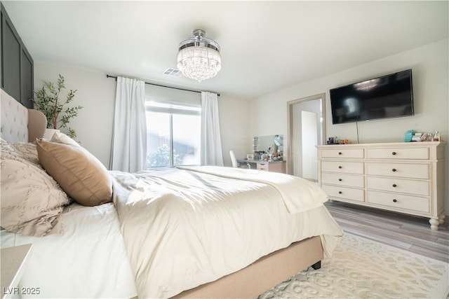 10183 Cascadia Creek St, Las Vegas, NV 89141 - bedroom featuring light wood-style flooring and a chandelier