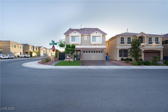10183 Cascadia Creek St, Las Vegas, NV 89141 - view of front facade with stucco siding, driveway, solar panels, an attached garage, and a residential view