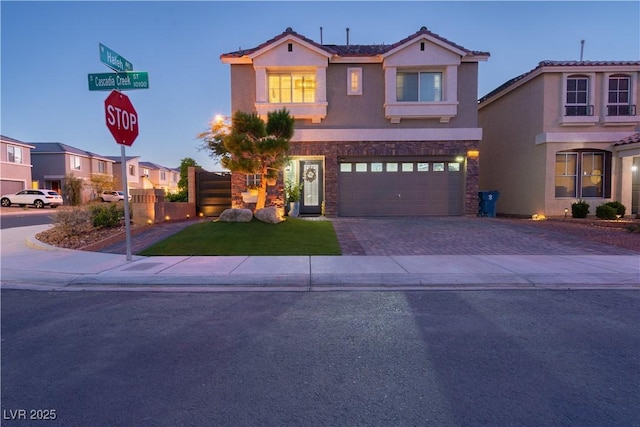 10183 Cascadia Creek St, Las Vegas, NV 89141 - view of front facade with stone siding, driveway, stucco siding, an attached garage, and a residential view