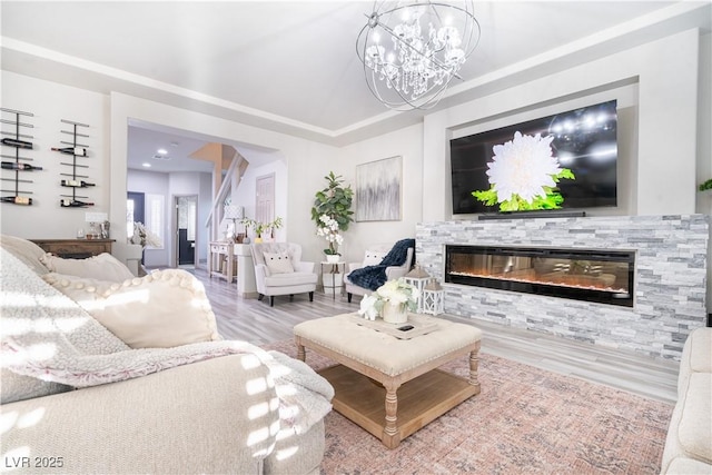 10183 Cascadia Creek St, Las Vegas, NV 89141 - living room featuring wood finished floors, a glass covered fireplace, and a chandelier