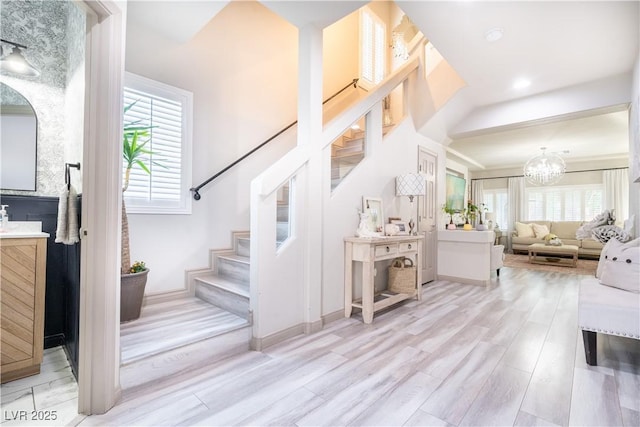10183 Cascadia Creek St, Las Vegas, NV 89141 - stairway with healthy amount of natural light, wood finished floors, and a chandelier