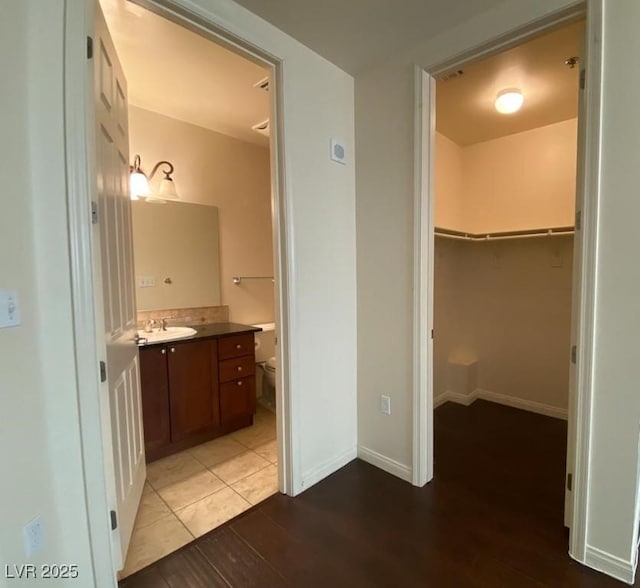 2405 Serene Ave Unit 241, Las Vegas, NV 89123 - bathroom featuring vanity, wood finished floors, and a spacious closet
