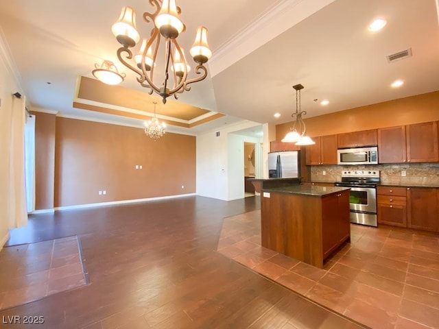 2405 Serene Ave Unit 241, Las Vegas, NV 89123 - kitchen featuring appliances with stainless steel finishes, ornamental molding, brown cabinets, a chandelier, and a raised ceiling
