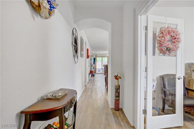 6324 Conlon St, North Las Vegas, NV 89081 - hallway with arched walkways, light wood-style flooring, and french doors