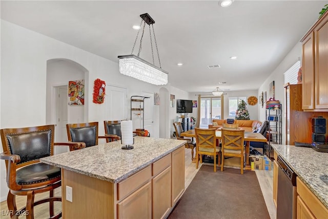 6324 Conlon St, North Las Vegas, NV 89081 - kitchen featuring stainless steel dishwasher, arched walkways, a breakfast bar, recessed lighting, and open floor plan