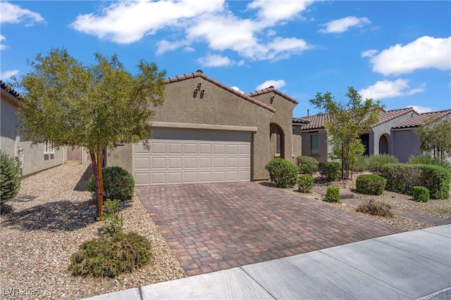 6324 Conlon St, North Las Vegas, NV 89081 - mediterranean / spanish home with a tiled roof, a garage, decorative driveway, and stucco siding