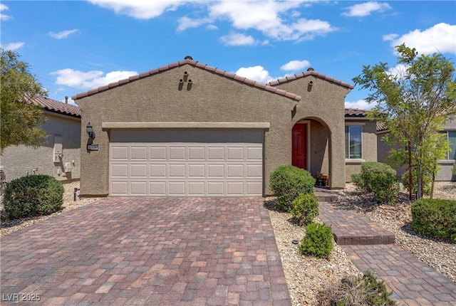 6324 Conlon St, North Las Vegas, NV 89081 - mediterranean / spanish-style house with a tiled roof, stucco siding, a garage, and decorative driveway